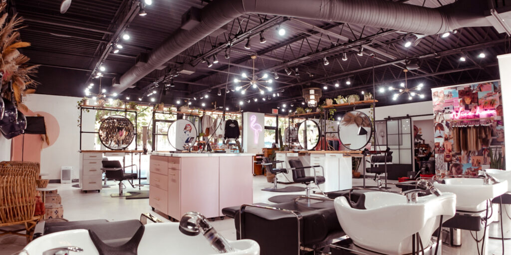 a picture of our salon from the back, at the bottom of the picture is our lay down shampoo bowls, then our baby pink color bar then our stations
